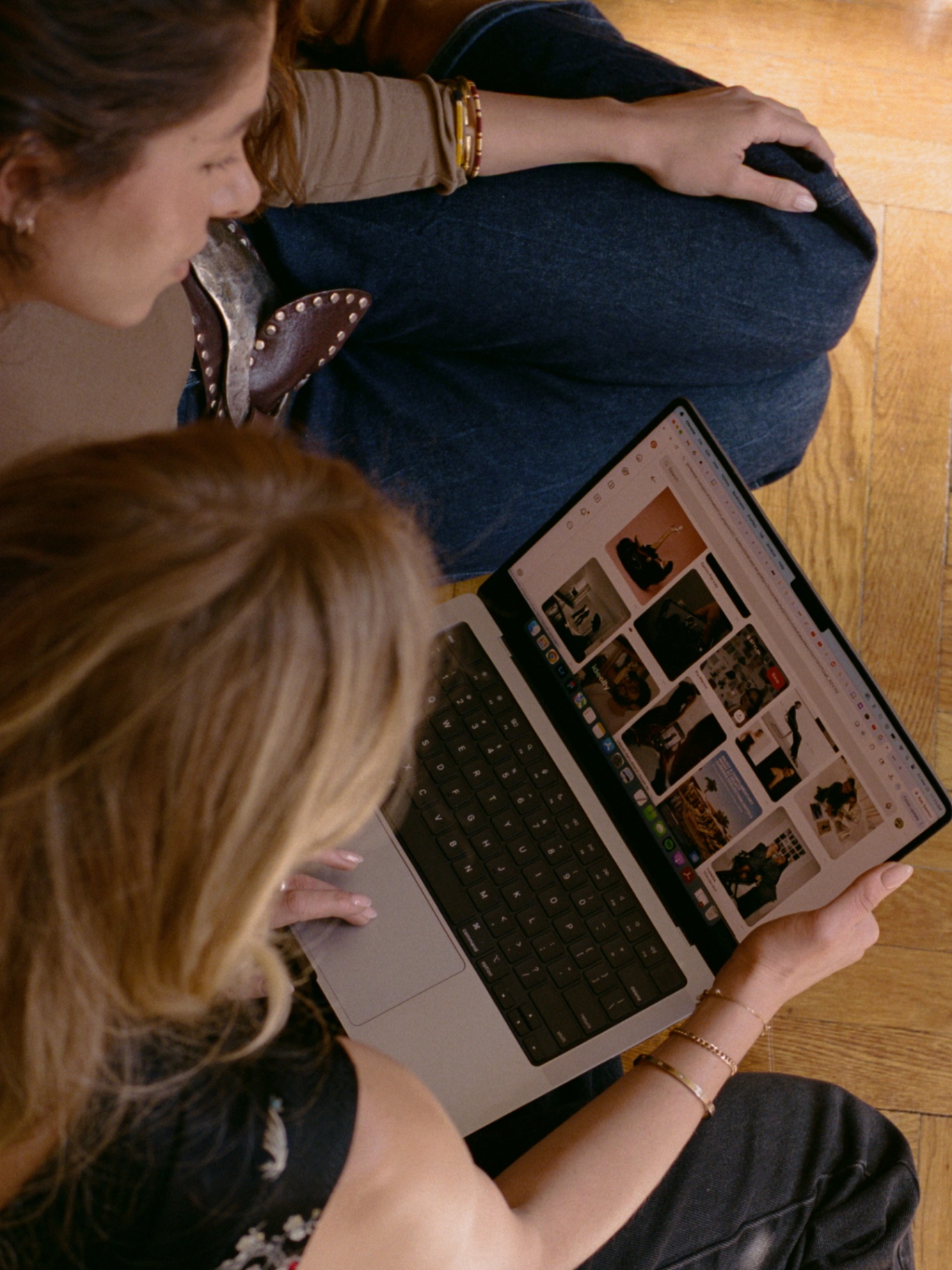 Stylist and client building a personal mood board on a laptop